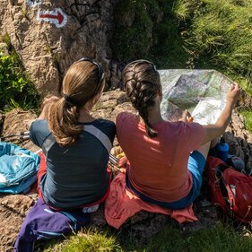 Zwei Wanderer schauen sich die Wanderkarte vom Wipptal an. | © TVB Wipptal - Helena Beermeister